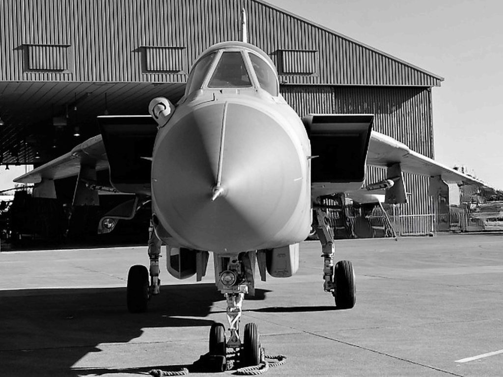 Senedd Photography Exhibition image: A black and white image of a tornado aircraft taken from the front end, looking down its nose.