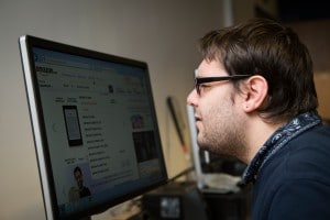 Image of a man looking at a computer screen