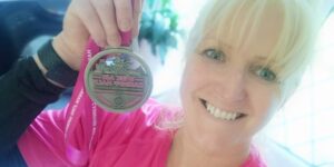Picture of Michelle with a medal from a previous half marathon event.