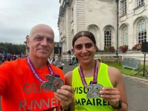 Rehnaz and her Guide Runner Mark with their medals.