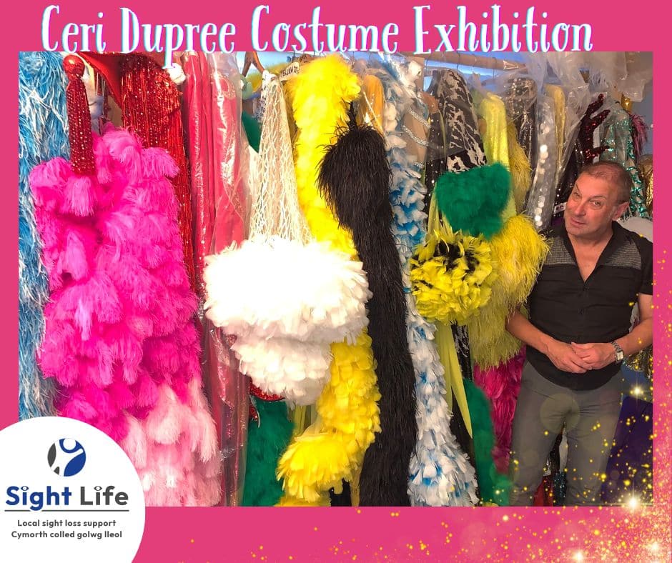 Ceri Dupree standing in front of a collection of his stage costumes.