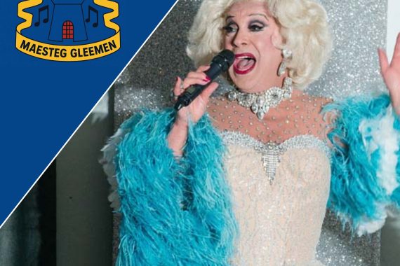 An image of Ceri Dupree looking glamorous in a white sequin frock and with a turqoise boa. He has a blonde wig on as well as diamante jewellery and is singing into the microphone, looking off to his right. Across the top right hand corner is a navy blue triangle, with the Gleemen Choir logo on it.