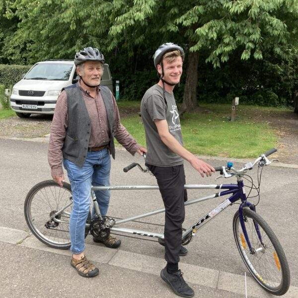 Volunteer and member on a tandem bike at Pedal Power