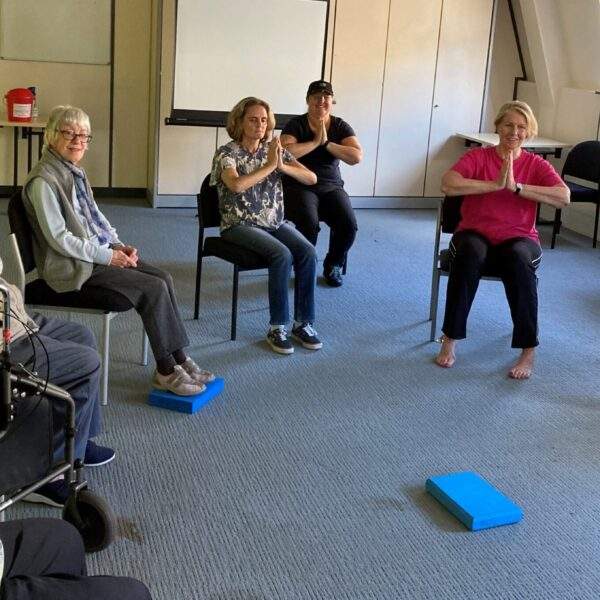 Members doing chair yoga