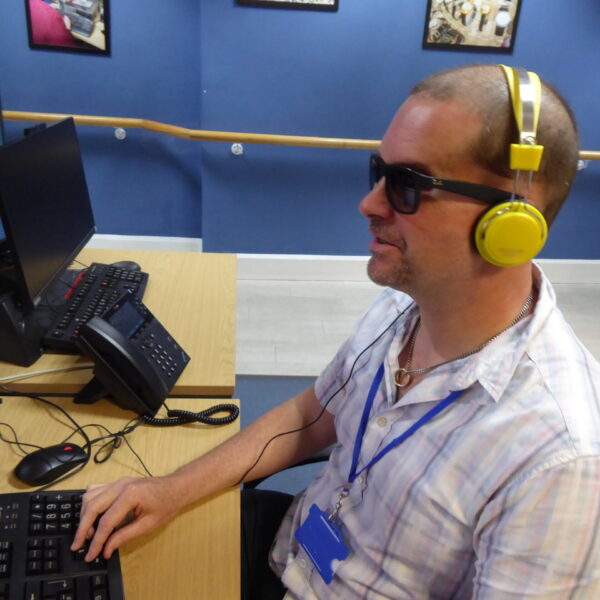 P1030881 Volunteer Stuart Ball sat at computer on contact line calls