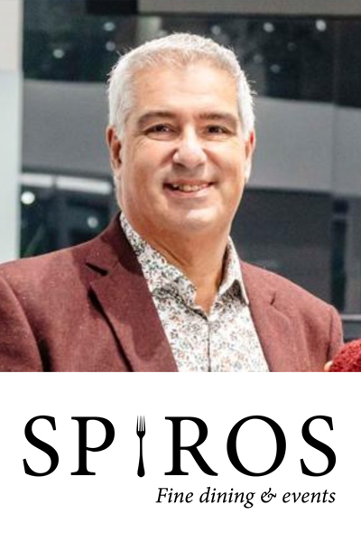 Head and shoulders shot of Spiro wearing a floral shirt with a brown jacket and smiling to camera. Underneath his phot is the Spiros Fine Dining & Events logo